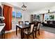 Bright dining area with a wooden table, comfortable seating, and a large window offering plenty of natural light at 585 Estes St, Lakewood, CO 80226