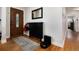 Inviting entryway with hardwood floors, stylish storage cabinet, and a beautiful wood door with decorative glass at 585 Estes St, Lakewood, CO 80226
