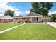 Charming brick home with well-manicured lawn, solar panels, and walkway at 585 Estes St, Lakewood, CO 80226