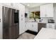 White cabinets and stainless appliances provide ample storage space in this updated kitchen at 585 Estes St, Lakewood, CO 80226