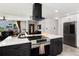 Open kitchen with stainless steel appliances and views of the living room and front entry at 585 Estes St, Lakewood, CO 80226