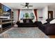 Comfortable living room with plush sofas, a ceiling fan, and a large window offering ample natural light at 585 Estes St, Lakewood, CO 80226