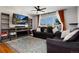 Inviting living room featuring a modern entertainment center, comfortable seating, and a bright, airy atmosphere at 585 Estes St, Lakewood, CO 80226