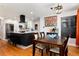Open-concept living space with a modern kitchen, a dining area, and hardwood floors, ideal for Gathering gatherings at 585 Estes St, Lakewood, CO 80226