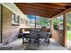 Covered patio area with outdoor dining set and wood accents, perfect for entertaining at 585 Estes St, Lakewood, CO 80226