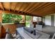 Cozy covered patio with dining set and a fire pit, ideal for outdoor relaxation and entertaining at 585 Estes St, Lakewood, CO 80226