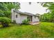Landscaped backyard with lush greenery, stone patio, and a well-maintained lawn at 182 Lois Cir, Louisville, CO 80027