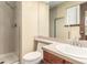 Bright bathroom featuring shower, toilet, sink, vanity, and glass shower door at 182 Lois Cir, Louisville, CO 80027