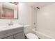 Bathroom featuring vanity with gray cabinet, toilet and tiled tub and shower combo at 182 Lois Cir, Louisville, CO 80027