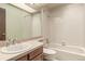 Bathroom with white tiled shower, a white sink with vanity and a large mirror at 182 Lois Cir, Louisville, CO 80027