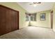 Bright bedroom with neutral carpet, a ceiling fan and a large closet with natural light at 182 Lois Cir, Louisville, CO 80027