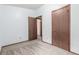 Clean, carpeted bedroom with neutral-painted walls, and two doorways at 182 Lois Cir, Louisville, CO 80027