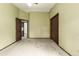 Spacious carpeted bedroom with a ceiling fan, neutral walls, and access to other rooms at 182 Lois Cir, Louisville, CO 80027