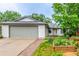 Charming home with a large front yard featuring raised garden beds and a brick walkway to the front door at 182 Lois Cir, Louisville, CO 80027