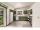 Spacious kitchen featuring plenty of storage, white appliances, and a pass-through window at 182 Lois Cir, Louisville, CO 80027