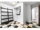 Laundry room featuring tiled flooring, washer, dryer and black shelving at 182 Lois Cir, Louisville, CO 80027
