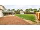 Lush backyard with a mix of lawn, garden space, shed, and partially covered patio at 2988 S Hannibal St, Aurora, CO 80013