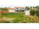 Expansive backyard with mature trees, a shed, and a two-story house featuring a deck at 2988 S Hannibal St, Aurora, CO 80013