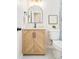 Stylish bathroom with a modern vanity, arched mirror, and neutral wall decor, creating a serene and inviting space at 2988 S Hannibal St, Aurora, CO 80013