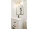 Modern bathroom vanity with black hardware, arched mirror, and decorative lighting at 2988 S Hannibal St, Aurora, CO 80013