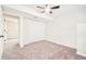 Empty bedroom with closet, ceiling fan, and neutral carpet at 2988 S Hannibal St, Aurora, CO 80013