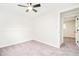 This well-lit bedroom offers a ceiling fan, neutral carpet, and easy access to adjacent rooms at 2988 S Hannibal St, Aurora, CO 80013