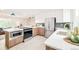 Bright kitchen featuring quartz countertops, stainless steel appliances, and trendy wood and white cabinetry at 2988 S Hannibal St, Aurora, CO 80013