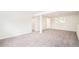 Spacious living room with neutral carpet and paint, a window, and a doorway at 2988 S Hannibal St, Aurora, CO 80013