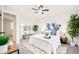 A well-lit bedroom with a ceiling fan, area rug, a large window, and calming decorations at 2988 S Hannibal St, Aurora, CO 80013