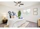 Comfortable bedroom offering a ceiling fan, a large window, and trendy decor at 2988 S Hannibal St, Aurora, CO 80013