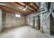 Unfinished basement with exposed ceiling, water tanks, and utility systems awaiting customization at 7150 Beach St, Westminster, CO 80030