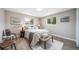 Bright bedroom with neutral decor, two windows, and stylish furnishings at 7150 Beach St, Westminster, CO 80030
