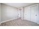 Bedroom featuring closet with white doors and view to adjoining bathroom at 7150 Beach St, Westminster, CO 80030