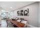 Modern dining room with a wooden table, gray chairs, and abstract artwork on the wall at 7150 Beach St, Westminster, CO 80030