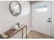 Bright entryway featuring light wood floors, a console table, and a front door with decorative windows at 7150 Beach St, Westminster, CO 80030