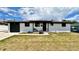 Charming single-story white home featuring a well-manicured lawn, black trim, and inviting curb appeal at 7150 Beach St, Westminster, CO 80030
