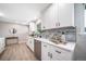 Modern kitchen with white cabinetry, stainless steel appliances, and elegant gray backsplash at 7150 Beach St, Westminster, CO 80030
