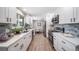 Bright eat-in kitchen with stainless steel appliances, white cabinets, and eat-in breakfast nook at 7150 Beach St, Westminster, CO 80030