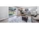 Open living room with wood floors, comfortable seating, and sliding glass doors to the backyard at 7150 Beach St, Westminster, CO 80030