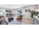 Open living room with wood floors, comfortable seating, and sliding glass doors to the backyard at 7150 Beach St, Westminster, CO 80030