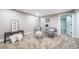 The cozy living room features neutral paint, plush carpet, and access to other rooms at 7150 Beach St, Westminster, CO 80030