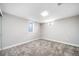 The empty room has neutral paint, plush carpet, and natural light from small windows at 7150 Beach St, Westminster, CO 80030
