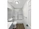 Bathroom featuring toilet and bathtub-shower combo with glass doors and wood-look flooring at 6731 S Ivy Way # B4, Centennial, CO 80112