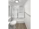 A clean bathroom featuring a shower with sliding glass doors, a modern toilet, and stylish flooring for a fresh look at 6731 S Ivy Way # B4, Centennial, CO 80112