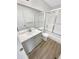 Bathroom featuring a mirror, sink, toilet and glass door shower with wood look floor at 6731 S Ivy Way # B4, Centennial, CO 80112