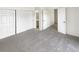 Bright bedroom with grey carpet, closet, and doorway leading to the rest of the home at 6731 S Ivy Way # B4, Centennial, CO 80112