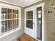 A close-up of the front door area with a window, displaying a welcoming entrance to the residence at 6731 S Ivy Way # B4, Centennial, CO 80112