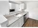 Bright kitchen area with white cabinetry and view to the living room fireplace at 6731 S Ivy Way # B4, Centennial, CO 80112