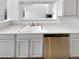 Bright and modern kitchen featuring white countertops, cabinetry and stainless steel dishwasher at 6731 S Ivy Way # B4, Centennial, CO 80112