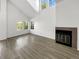 Bright living room with vaulted ceiling, fireplace, and ample natural light showcasing an open and airy design at 6731 S Ivy Way # B4, Centennial, CO 80112